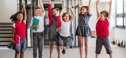 a-group-of-cheerful-small-school-kids-in-corridor-jumping-1